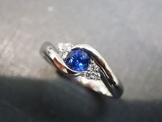 Product Specifications: - 4mm High quality natural Blue Sapphire at the center - 6 Round Brilliant cut Diamonds, total carat around 0.09ct - D-F in color and VS in clarity with Heart and Arrow (Ideal cut) - 14K white gold - Ring Width: 2.3mm Pls check the product video from below link, https://www.instagram.com/p/B7S0QMUh_MD/ Currently made to order pieces may take up to 10-15 business days to complete, or let me know if you need it urgent. It's easy to create jewelry that's perfect for you. Cha Blue Sapphire Ring With Tension Setting For Wedding, Blue Sapphire Wedding Ring With Tension Setting, Wedding Blue Sapphire Ring With Tension Setting, Blue Sapphire Ring With Tension Setting For Promise, Blue Sapphire Ring In Fine Jewelry Style, Blue Diamond Rings With Tension Setting, Elegant Blue Sapphire Ring With Tension Setting, Blue Ring With Tension Setting For Wedding, Round Cut Sapphire Ring With Tension Setting