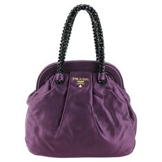 Prada purse in silk color purple, dark stones handle, gold hardware. Condition: Really good. Packing/accessories: Dustbag. Measurements: Width: 20 cm Height: 21 cm Depth: 8 cm Prada Bag Purple, Packing Accessories, Prada Purse, Prada Purses, Purple Handbags, Silk Jewelry, Purple Bag, Purple Dark, Purple Silk