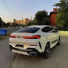 the rear end of a white bmw suv