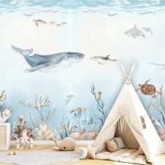 a child's room with a teepee tent and sea animals on the wall