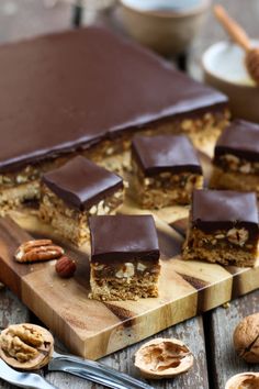 several pieces of chocolate and nuts on a cutting board