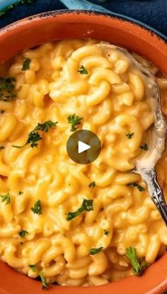 an orange bowl filled with macaroni and cheese