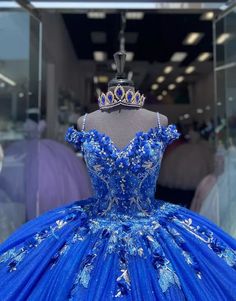 Make a grand entrance in this Royal Blue Ball-Gown Quinceañera Dress. This dress is crafted from layers of luxurious tulle and flows elegantly into a chapel train, adding to its regal charm. The off-the-shoulder neckline and sweeping ball gown silhouette create a majestic look, perfect for a special celebration. The exquisite appliques and shimmering beading embellish the bodice and skirt, enhancing the gown with intricate details and a touch of sparkle. The lace-up back allows for a beautifully Quince Royal Blue Dress, Royal Blue Quince Dress, Blue Quince Dress, Royal Blue Ball Gown, Royal Blue Quinceanera Dresses, Royal Blue Quince, Royal Blue Quinceanera, Gown Silhouette, Dresses With Appliques