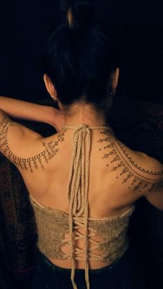 a woman with tattoos on her back