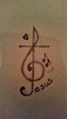 a cross and musical notes drawn on paper with the word jesus written in cursive writing