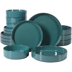 a set of green dishes and cups