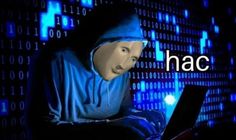 a person wearing a hoodie using a laptop in front of a blue background with the word hac