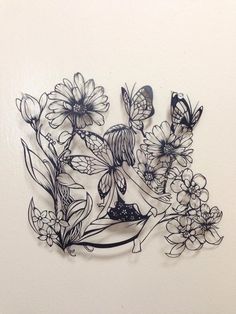 a drawing of flowers and butterflies on a white wall