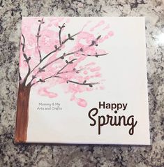 a card with the words happy spring written on it and a tree painted in pink