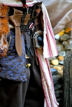 a close up of a person wearing a costume and holding a cell phone in his hand