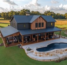 an aerial view of a house with a hot tub in the foreground and a pool on the other side