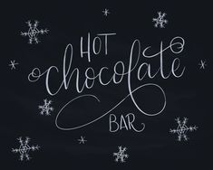 the words hot chocolate bar written in white chalk on a black background with snowflakes