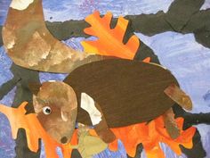 an animal made out of construction paper on a blue background with orange and black leaves