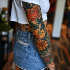 a woman with a flower tattoo on her left arm and half - sleeved shirt