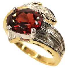 This Vintage IGI Vertified 1.21ct Oval-cut Orangy Red Garnet Diamond 20K Gold Ring is a stunning piece of jewelry that is sure to turn heads. The centerpiece of the ring is a beautiful 1.21 carat natural oval cut deep orangy red pyrope-almandite garnet. The gemstone has a rich, warm hue that is truly captivating, and it is of exceptional quality, with a clarity that is visible to the naked eye. The garnet is a timeless and elegant gemstone that has been prized for centuries, and this particular Gold Ring Vintage, Garnet And Diamond Ring, Baguette Diamond, Red Garnet, Belleza Natural, Ring Vintage, Gold Design, Cocktail Rings, Oval Cut