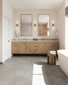 a large bathroom with two sinks and mirrors