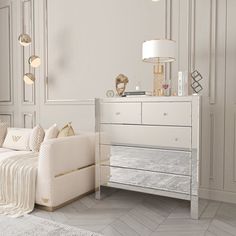 a living room with white furniture and gold accents on the walls, carpeted flooring