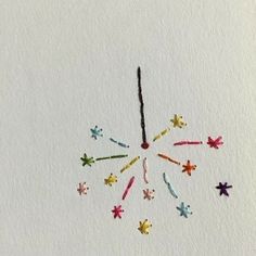 a clock made out of colored crayons on a white paper background with stars