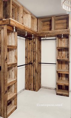 an empty room with wooden shelves and shelving unit in it's center area