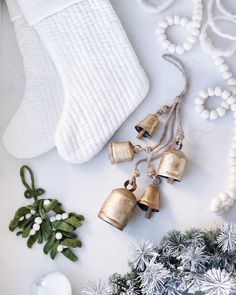 christmas decorations including bells and garland on a white surface