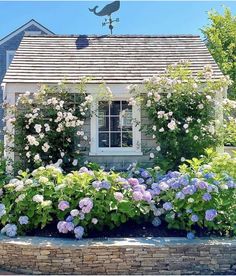 a house with flowers in the front yard