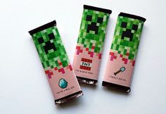 two candy bars are decorated like the creeper from minecraft on a white surface