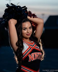 a beautiful young lady wearing a cheerleader uniform