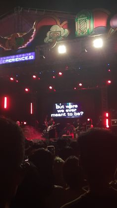 the stage is lit up with bright lights and people are sitting in front of it