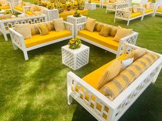 yellow and white outdoor furniture set up on the grass