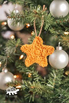 a crocheted star ornament hanging from a christmas tree