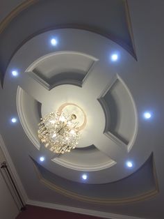 a white ceiling with lights and a chandelier