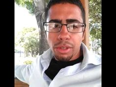 a man wearing glasses and a white shirt is making a funny face at the camera