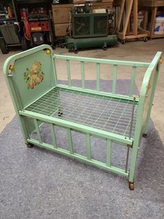 a green metal bed frame with winnie the pooh sticker on it's side