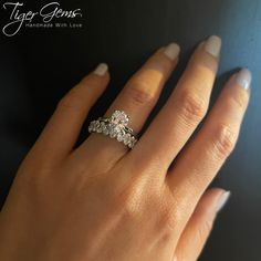 a woman's hand with three diamond rings on her left and the middle finger