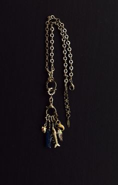 Brass Amulet Charm Necklaces, Brass Amulet Style Charm Necklaces, Dangle Charm Amulet Necklace, Dangle Charms Amulet Necklace, Amulet Style Pendant Charm Necklace With Dangling Charms, Amulet Style Charm Necklace With Dangling Pendants, Amulet Necklaces With Charms, Amulet Style Dangle Necklace With Charms, Metal Necklaces With Dangling Pendant Charms