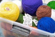 several balls of yarn in a plastic container