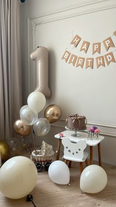 a birthday party with balloons, cake and decorations