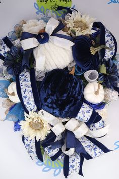 a blue and white wreath with flowers on it