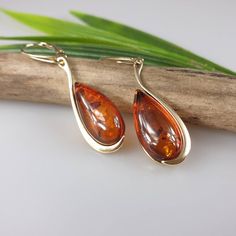 Amber earrings. Cognac - brown Amber. Gold plated Sterling silver 925 with hallmarks. Genuine Amber. Suitable pendant is also available please contact me for more details. Lever back lock. About 4.5 cm length. https://www.etsy.com/shop/AmberLithuania?ref=simple-shop-header-name&listing_id=780205095&section_id=27948198 This item was made of natural Baltic Amber. All the amber used in my jewelry is collected in my home country Lithuania. I sell only genuine, real, not pressed, authentic, n Amber Drop Earrings, Elegant Brown Teardrop Pierced Earrings, Elegant Tortoiseshell Drop Earrings, Elegant Amber Earrings With Polished Finish, Brown Teardrop Earrings For Formal Occasions, Formal Baltic Amber Drop Earrings, Formal Brown Teardrop Earrings, Formal Baltic Amber Earrings, Baltic Amber Drop Earrings