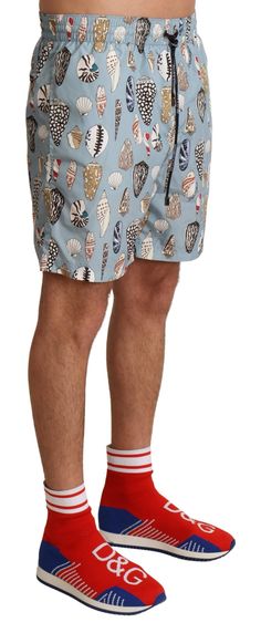 Step into the summer with style wearing these elegant swim trunks by Dolce & Gabbana. These trunks are not only a showcase of fashion excellence but also a testament to comfort and durability. Featuring a sophisticated blue seashell print, they’re perfect for any beach getaway or poolside relaxation. Equipped with an elastic waist and multiple pockets, these shorts marry practicality with Dolce & Gabbana’s iconic luxury appeal. Color: Blue Material: 100% Polyester Country of origin: IT Elastic w Blue Seashell, Beachwear Swimwear, Seashell Print, Dolce And Gabbana Blue, Mens Trunks, Swimming Trunks, Swimwear Shorts, Dolce E Gabbana, Printed Swim