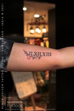 a person with a tattoo on their arm that says millixlixl and has an arrow in the middle