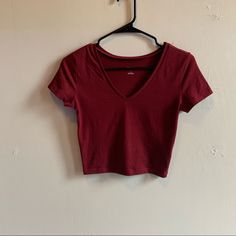 A Slightly Cropped V-Neck Fitted Tee By Wild Fable In A Beautiful Burgundy Color. Size Small. It Is Brand New Never Been Worn, I Ordered Online And Only Wore It To Try It One, Unfortunately The Tags Got Pulled Off While Trying It On So I Can’t Return It As It Was To Small. It’s A Great Tee That Is Super Flattering And Hits All The Right Spots On Your Body. I Know I Reorders A Size Up! Red Fitted V-neck Top, Basic V-neck Top For Summer, Spring Casual Low-cut Tops, Casual Low-cut Tops For Spring, Casual Low-cut Spring Tops, Basic V-neck Stretch Crop Top, Red Stretch V-neck T-shirt, Red V-neck Casual T-shirt, Red Cotton V-neck Crop Top