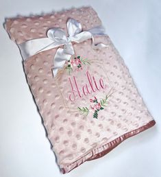 a pink polka dot blanket with a name on it