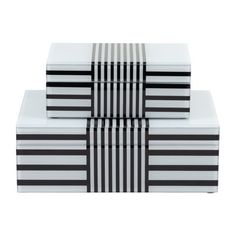 three boxes with black and white stripes stacked on top of each other, one is empty