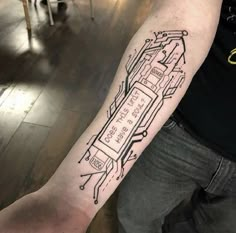 a man with a tattoo on his arm that has a circuit board in the shape of a car