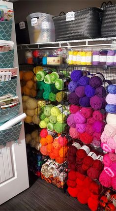 the shelves are filled with yarn and crochet hooks, baskets, and storage bins