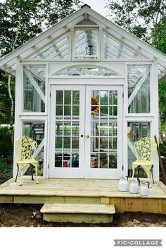 a small white house with two yellow chairs