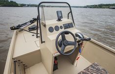 there is a steering wheel on the front of a boat that is in the water