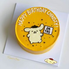 a yellow birthday cake with an image of a cartoon character on the front and side