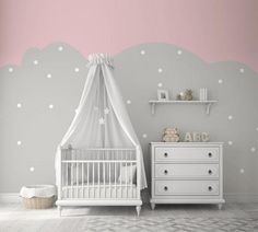 a baby's room decorated in pink and gray with white polka dots on the walls